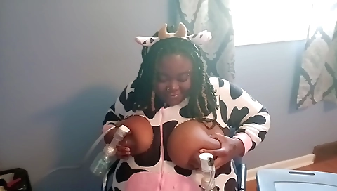 Busty black woman with huge tits stretching her pussy