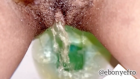 Ebony chick pissing up close in POV solo porn clip