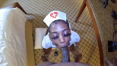 Ebony nurse with a huge black cock gives a blowjob