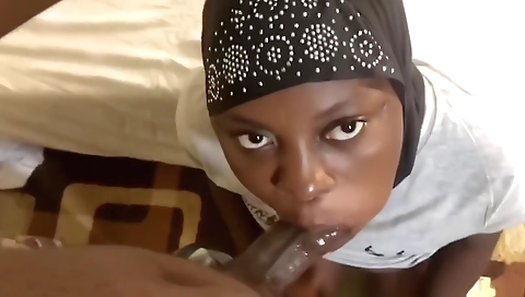 Ebony brunette with a hairy pussy sucking a huge dick