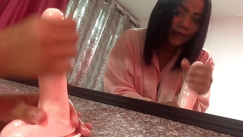 Amateur brunette is playing with a black toy on the webcam