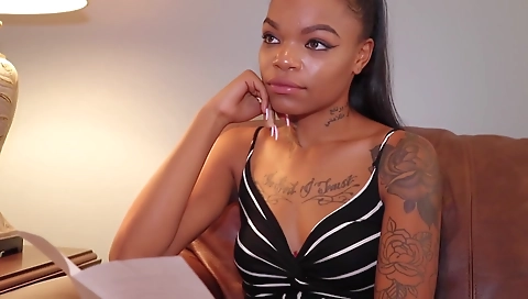 Ebony brunette with a tattooed pussy gets on the toilet