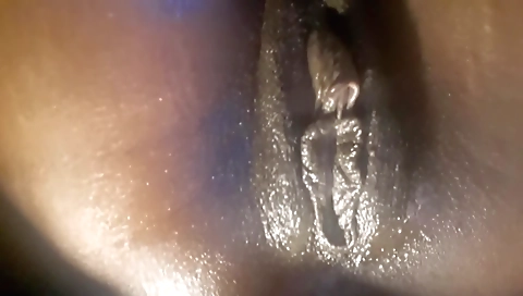 Ebony hottie with a fat pussy is showing off on the sofa