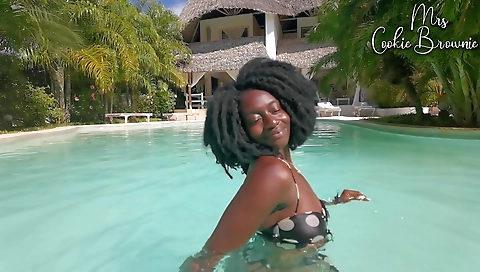 Sexy ebony babe with a sexy booty sits on the pool