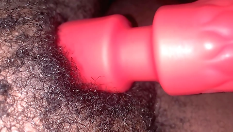 Ebony girl with a hairy pussy uses a toy to masturbate