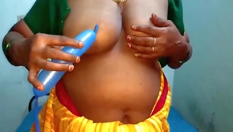 Ebony lady with big boobs shows off while using a dildo