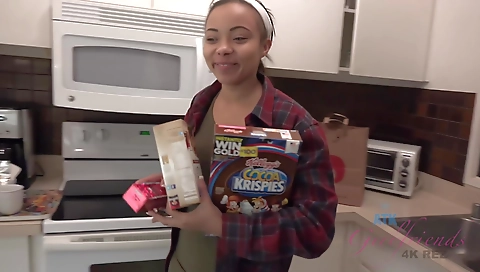 Ebony woman in a black trench coat in a hot outdoor video