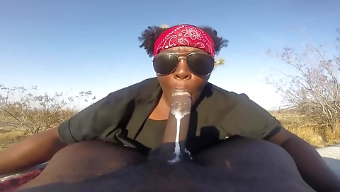 Busty brunette milf in outdoor public area with a cock